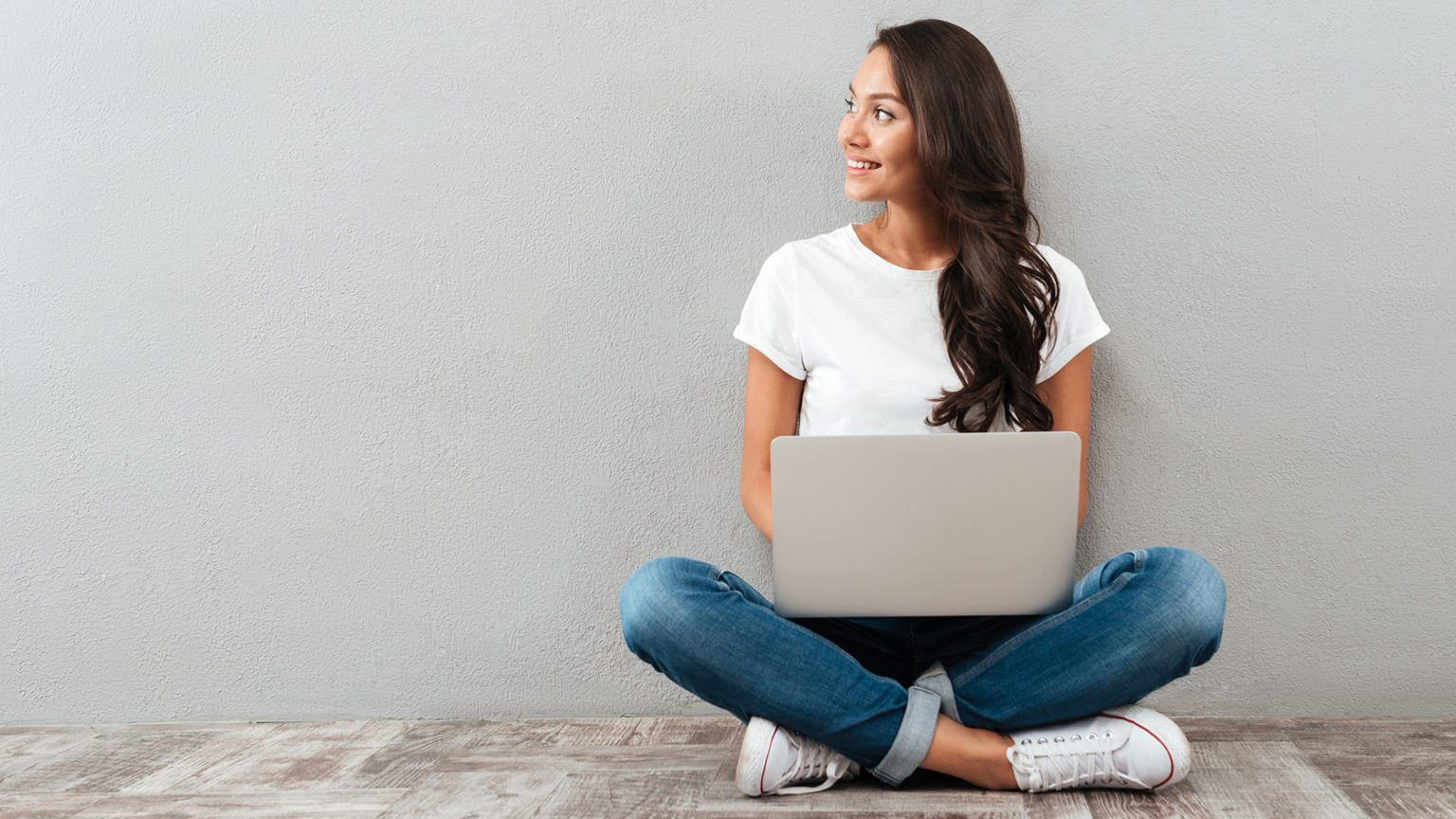 Attractive asian woman holding laptop